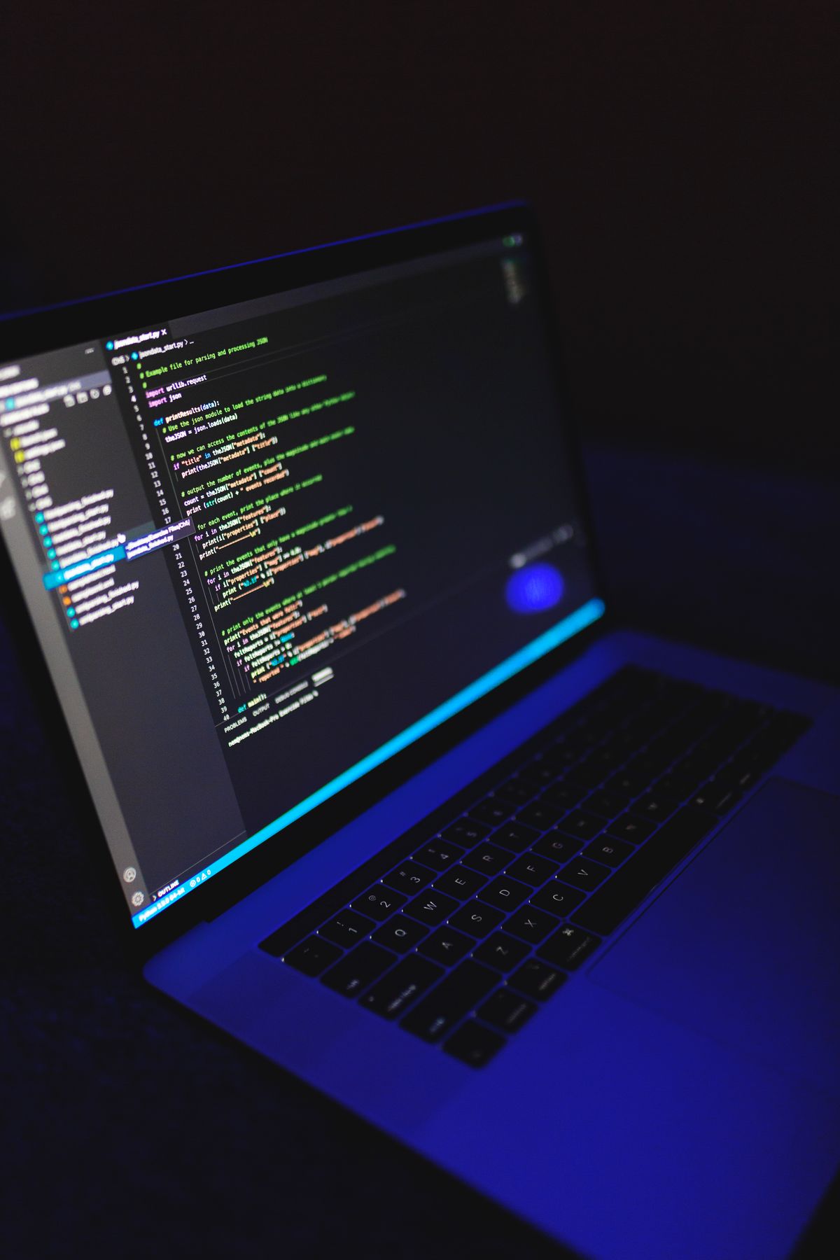 Laptop showing a code editor in a developer workspace — AI Agent monthly cost breakdown from solo to team