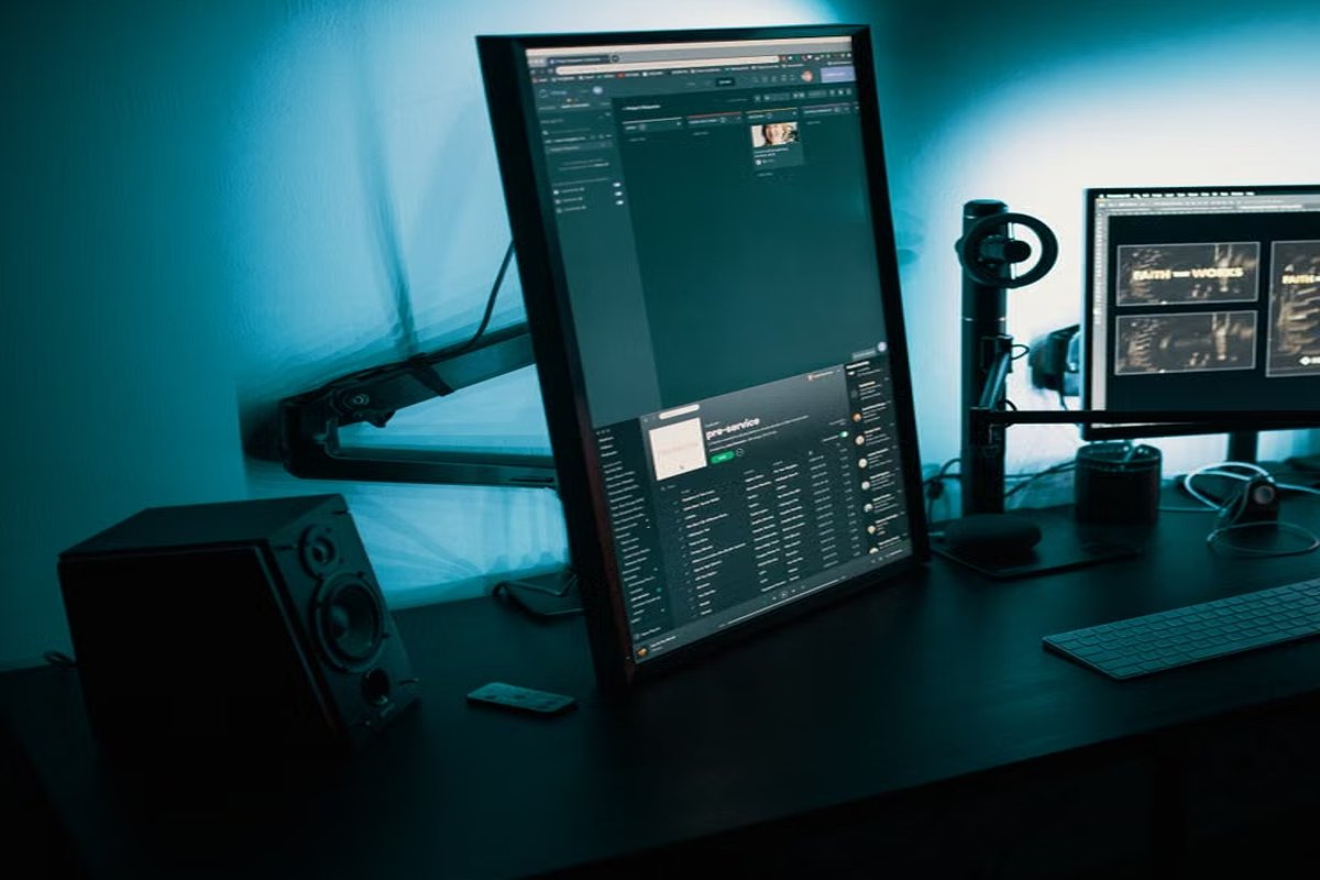 Bureau développeur avec moniteurs verticaux affichant logs et interface technique